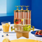 Elegant Triple Section Glass Beverage Dispenser with Gold Deer Lid, Wooden Stand, Round Design, Perfect for Gatherings.