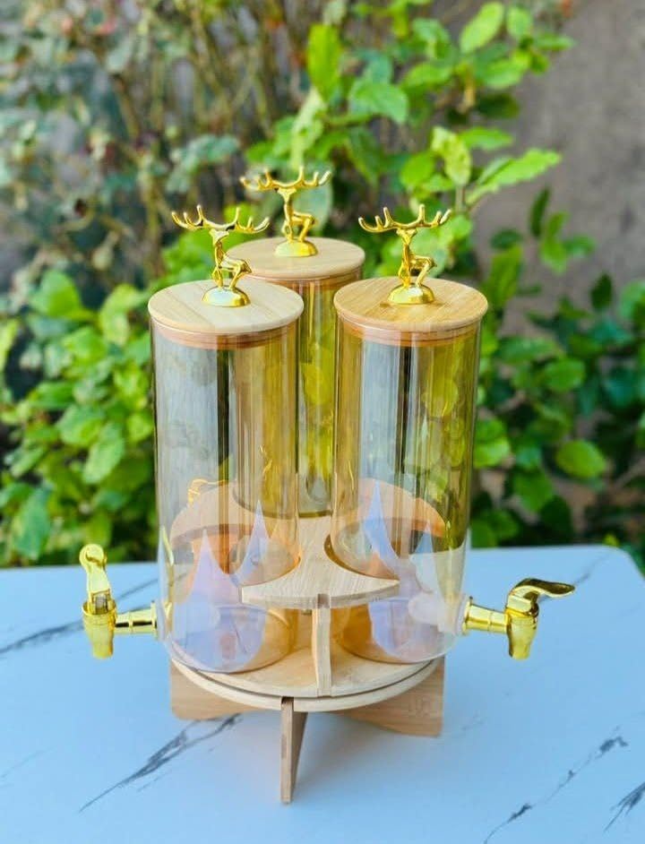 Elegant Triple Section Glass Beverage Dispenser with Gold Deer Lid, Wooden Stand, Round Design, Perfect for Gatherings.